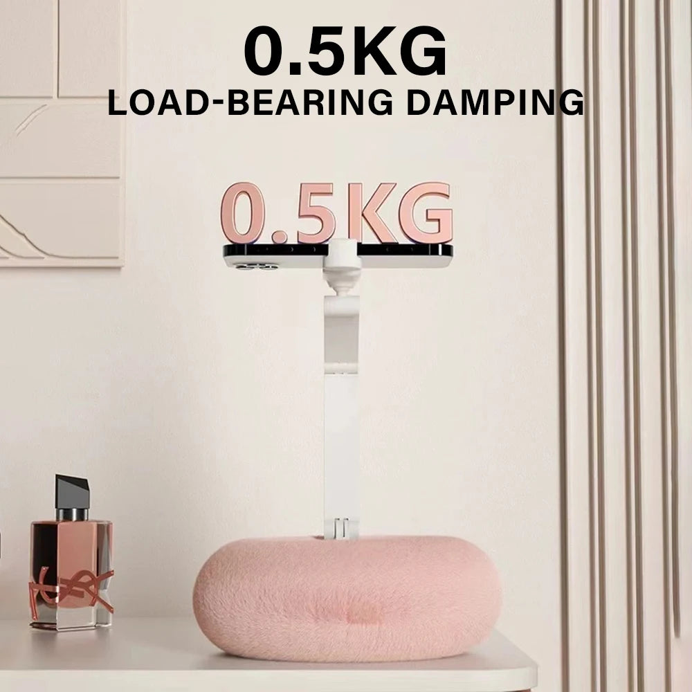 Pink cushion on a surface with a scale displaying 0.5KG and text about load-bearing damping.